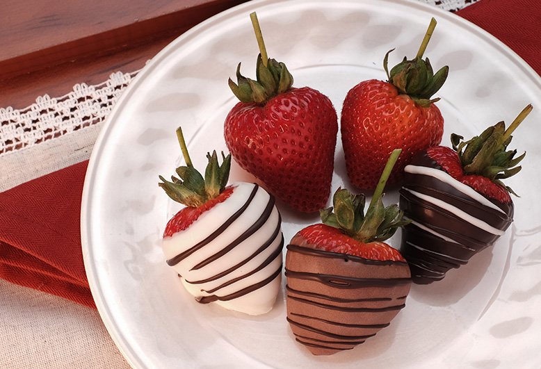 Chocolate covered strawberries on white plate Gertrude Hawk
